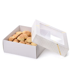 A luxurious box for maamoul and sweets with a transparent lid and golden decoration